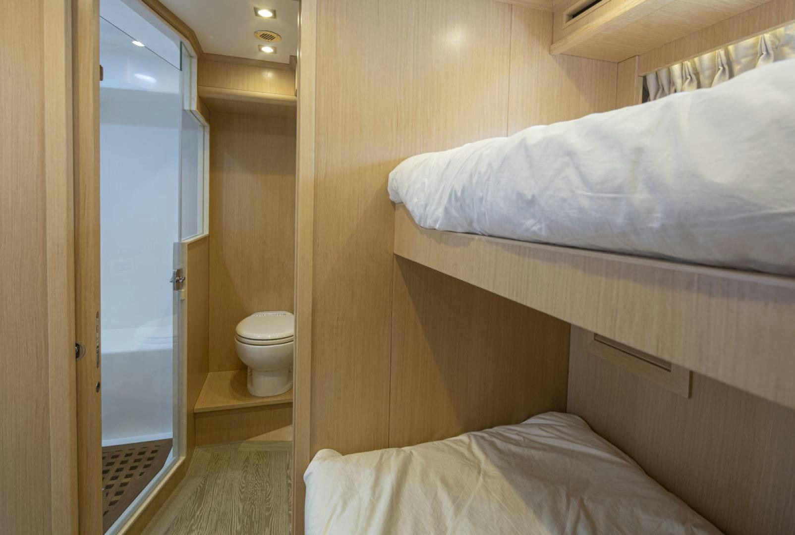 a bedroom with a bed and a door aboard PARAGON COCKPIT Yacht for Sale