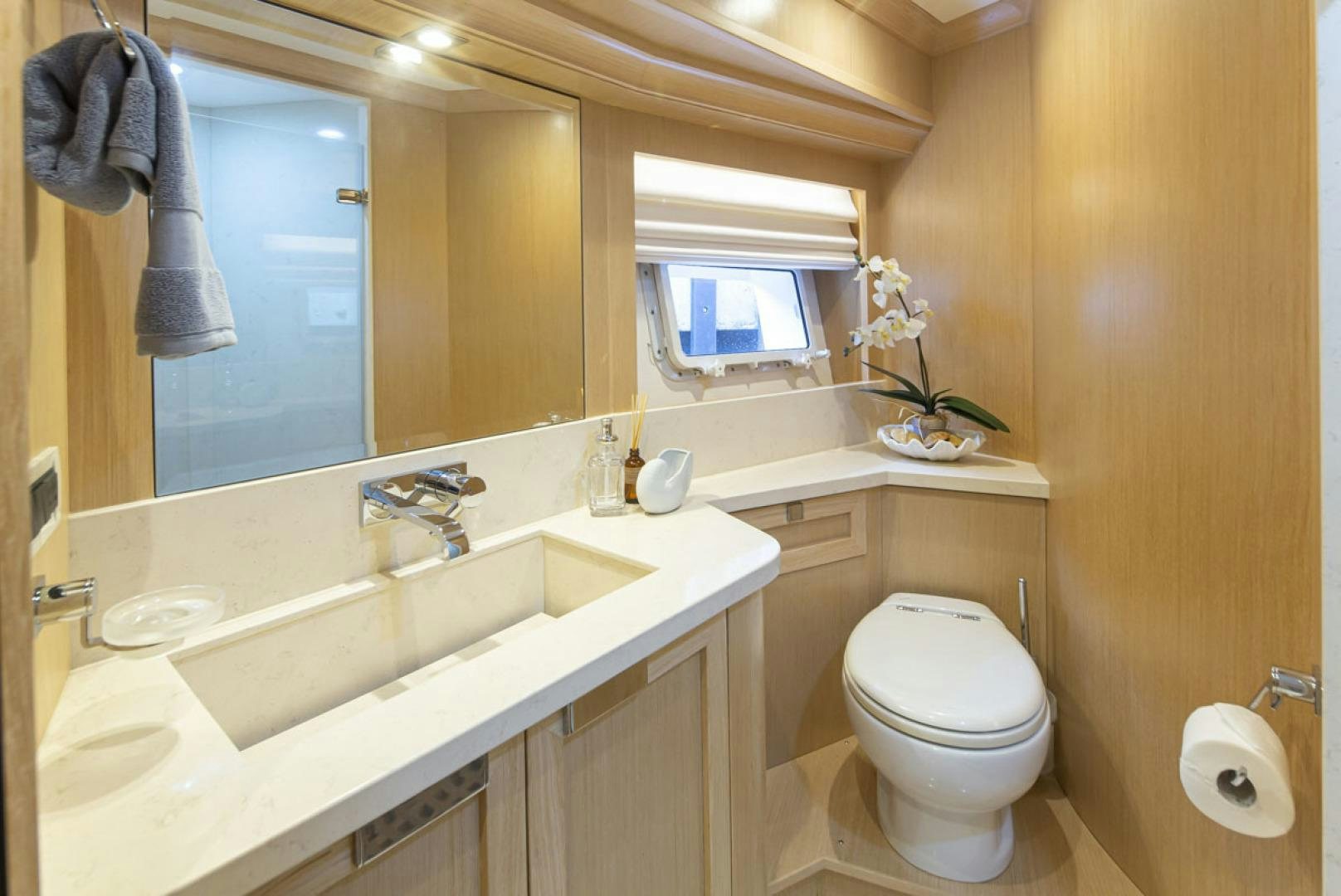 a bathroom with a toilet and sink aboard PARAGON COCKPIT Yacht for Sale