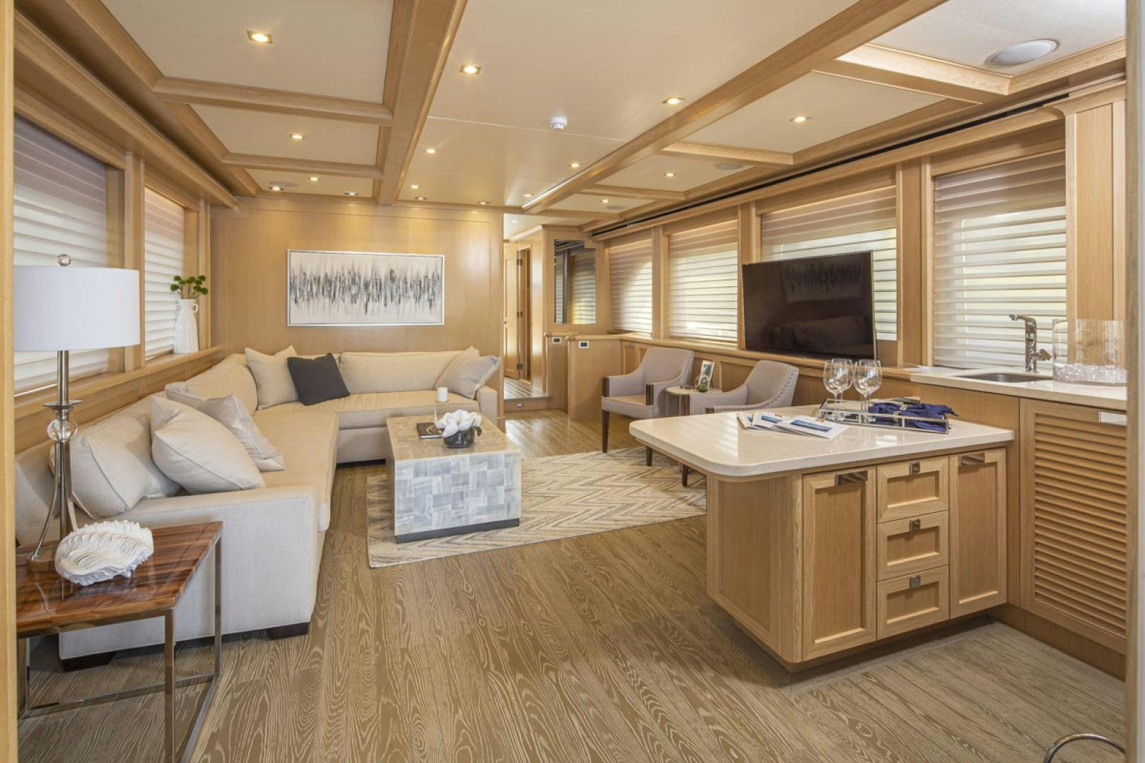 a living room with a large wood floor and a large window aboard PARAGON COCKPIT Yacht for Sale