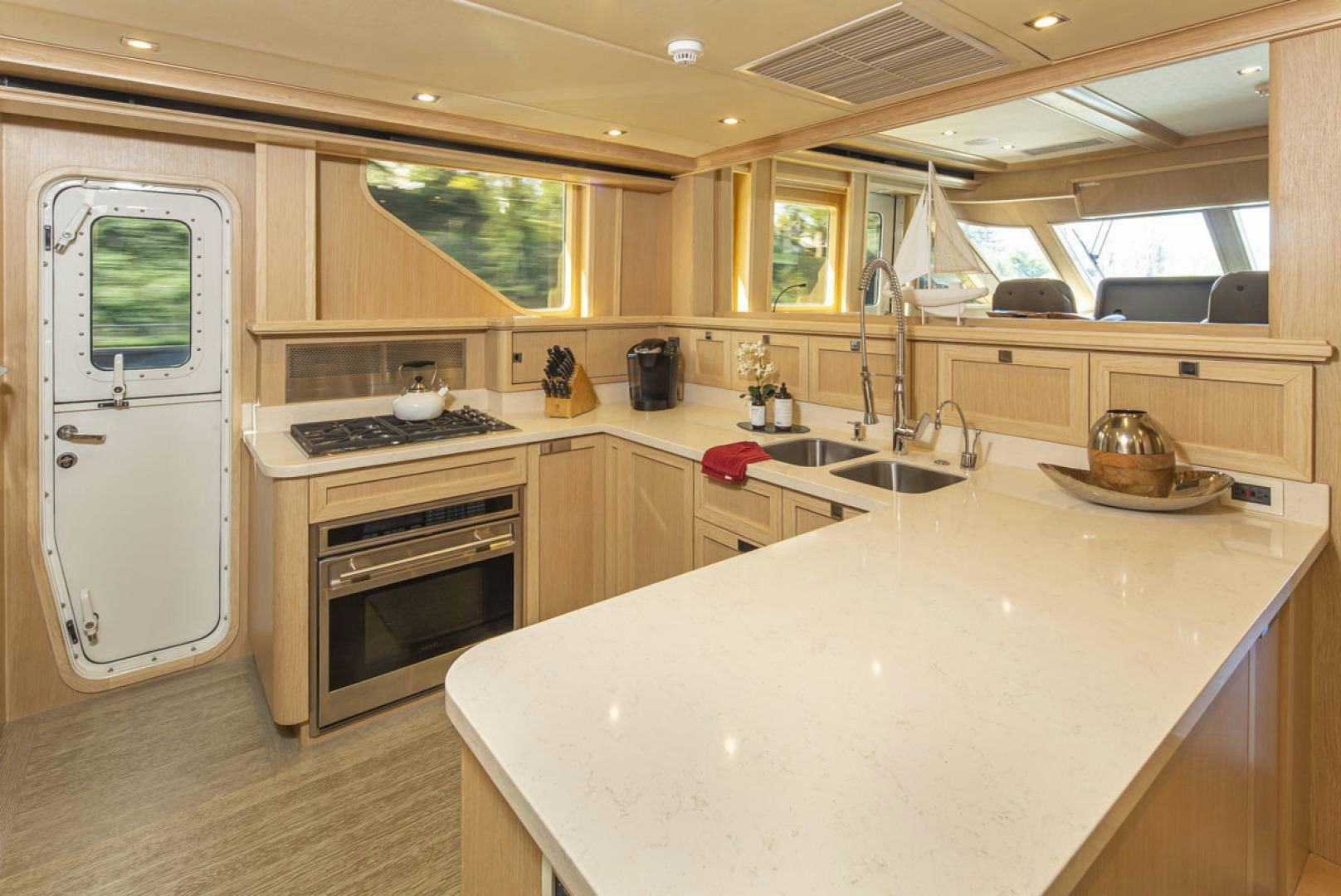 a kitchen with a large island aboard PARAGON COCKPIT Yacht for Sale