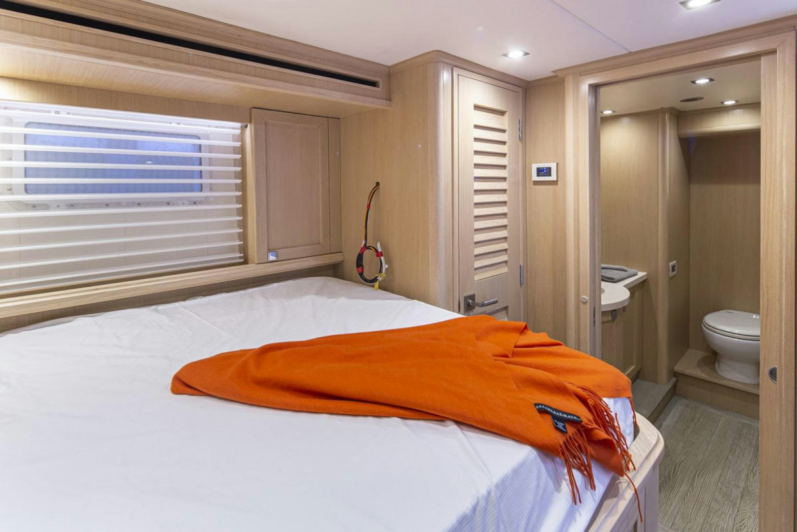 a bedroom with a bed and a closet aboard PARAGON COCKPIT Yacht for Sale