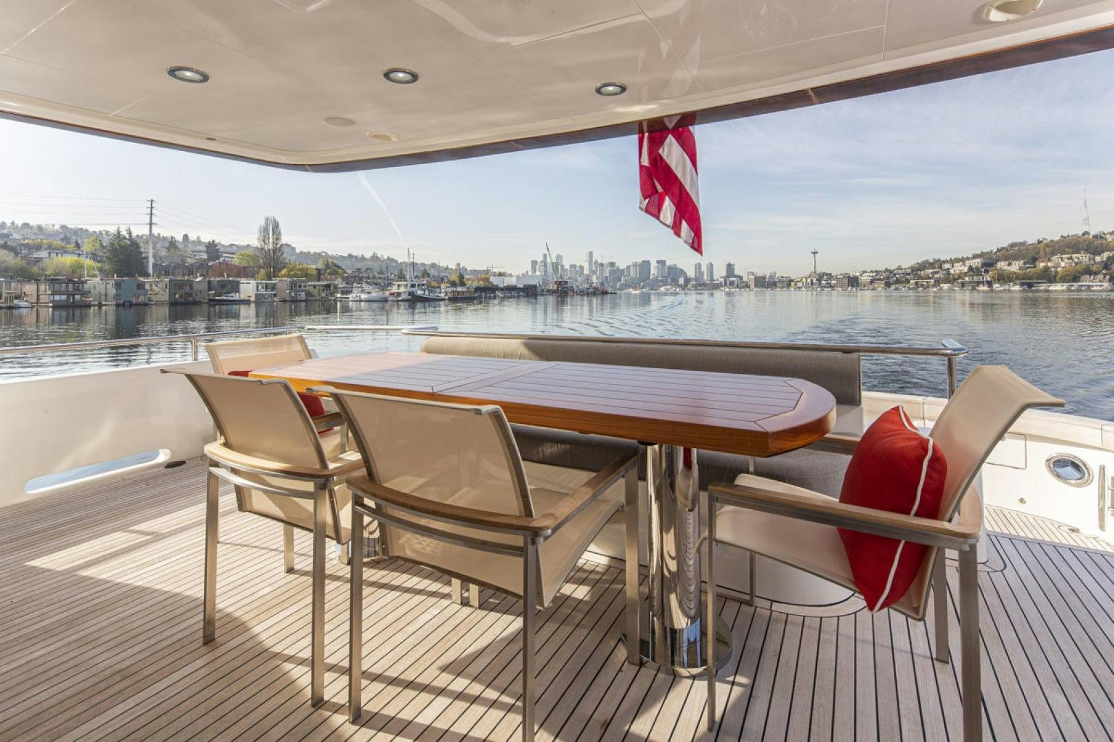 a deck with chairs and a table on it aboard PARAGON COCKPIT Yacht for Sale