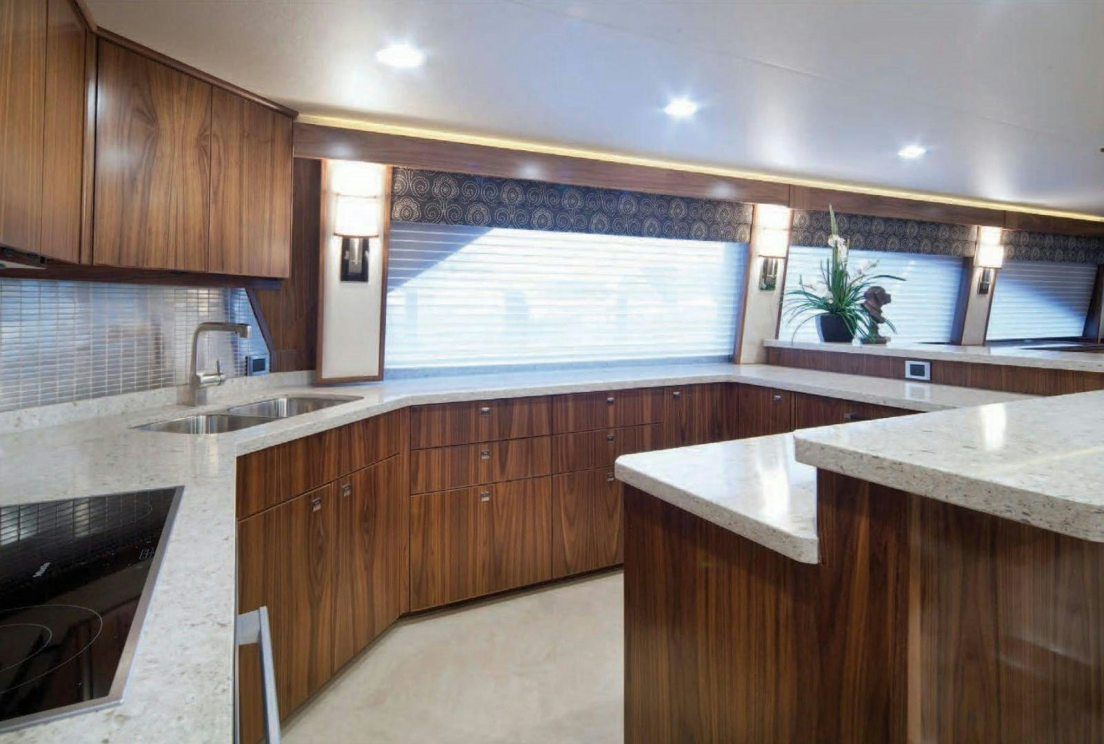 a kitchen with wooden cabinets aboard 2022 Yacht for Sale