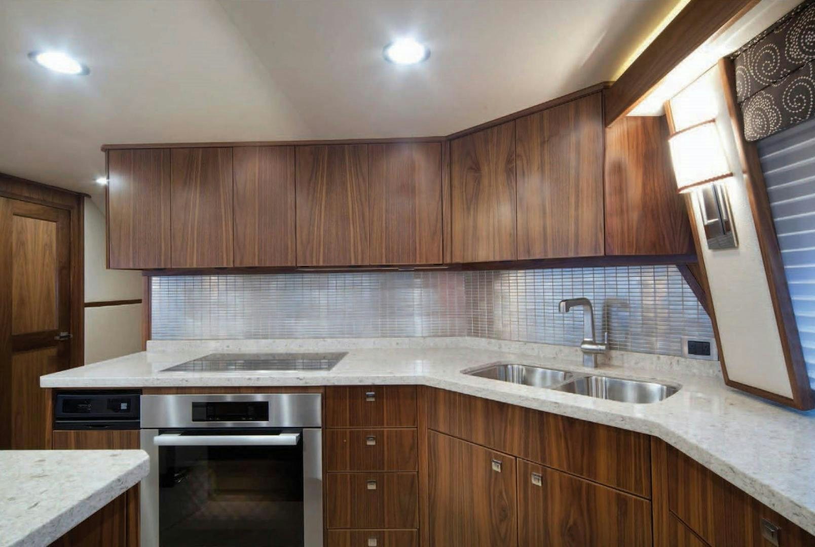 a kitchen with wooden cabinets aboard 2022 Yacht for Sale