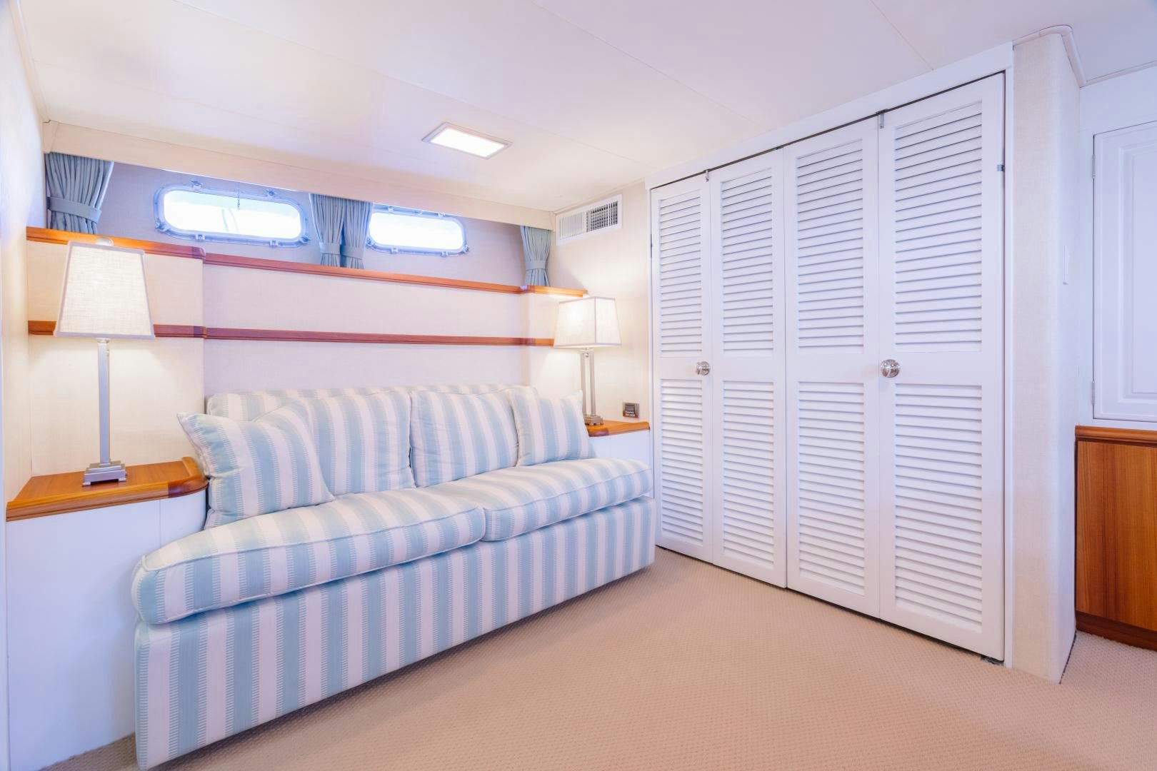 a living room with a couch and a white door aboard NORDIC STAR Yacht for Sale