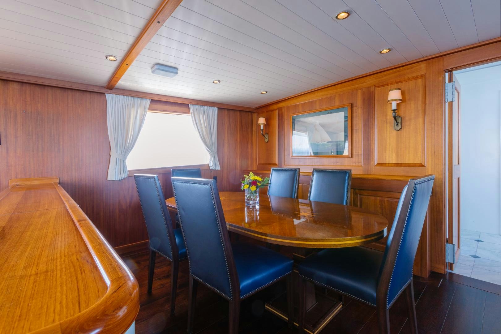 a dining table and chairs in a room aboard NORDIC STAR Yacht for Sale