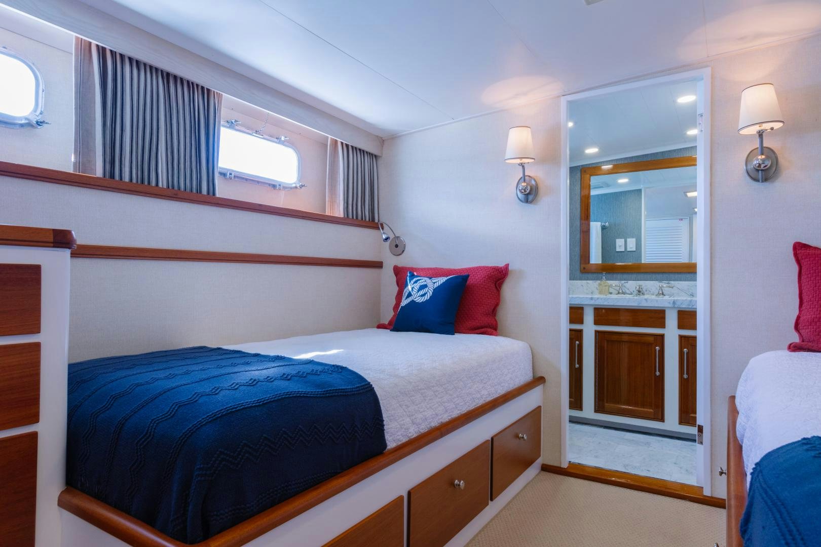 a bedroom with a bed and a mirror aboard NORDIC STAR Yacht for Sale