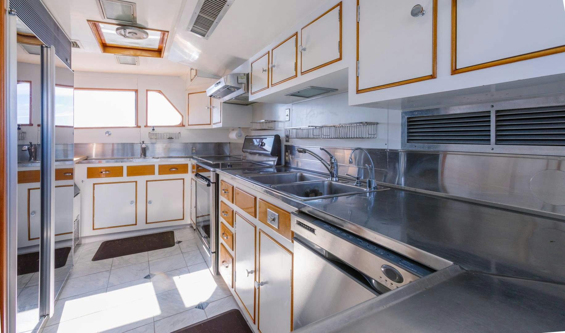 a kitchen with white cabinets aboard NORDIC STAR Yacht for Sale