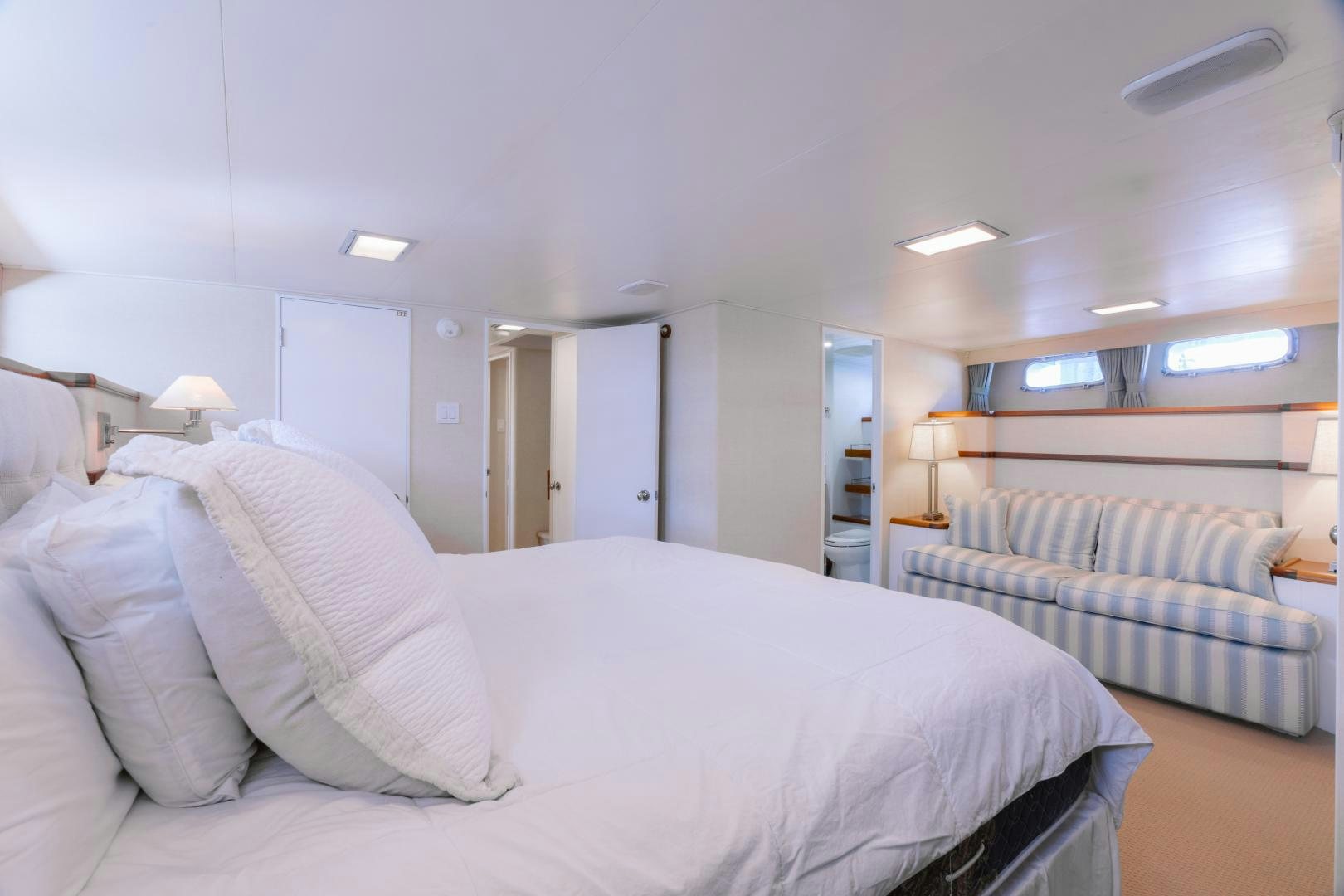 a bedroom with a bed and a couch aboard NORDIC STAR Yacht for Sale