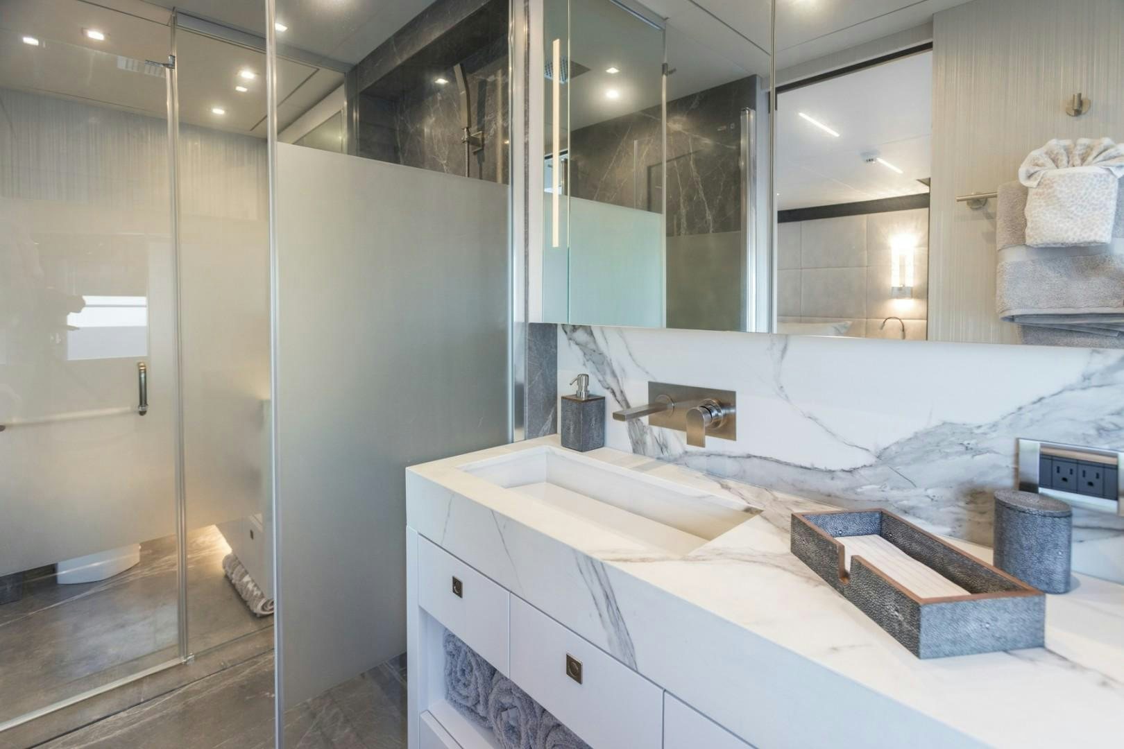 a bathroom with a large mirror aboard No Name Yacht for Sale