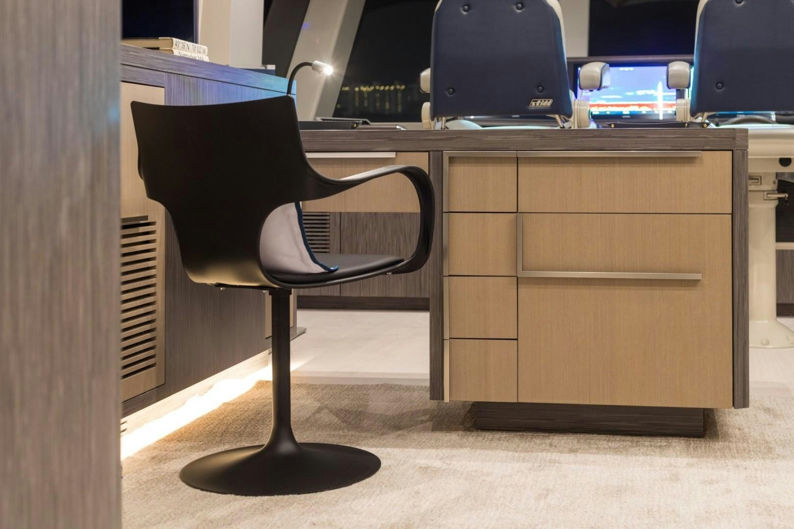 a chair and desk in a room aboard No Name Yacht for Sale