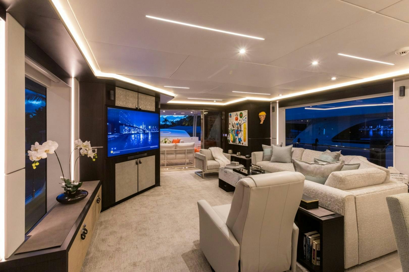 a living room with a large screen aboard No Name Yacht for Sale