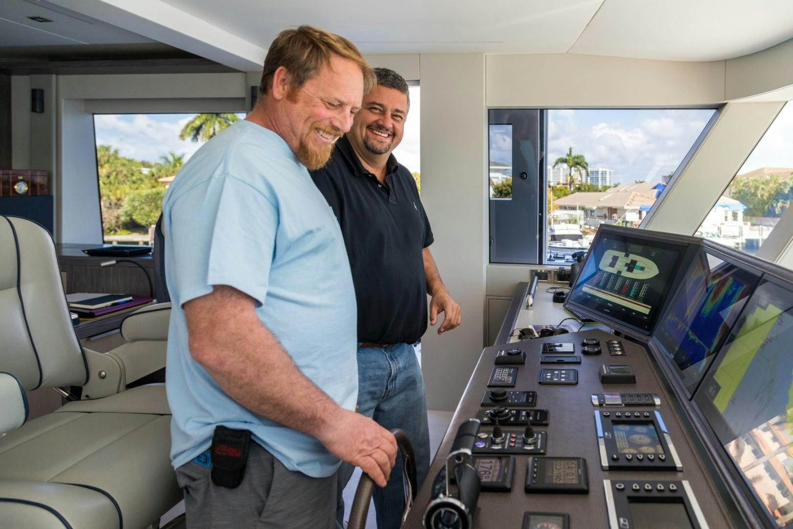 men standing in front of a row of computers aboard No Name Yacht for Sale