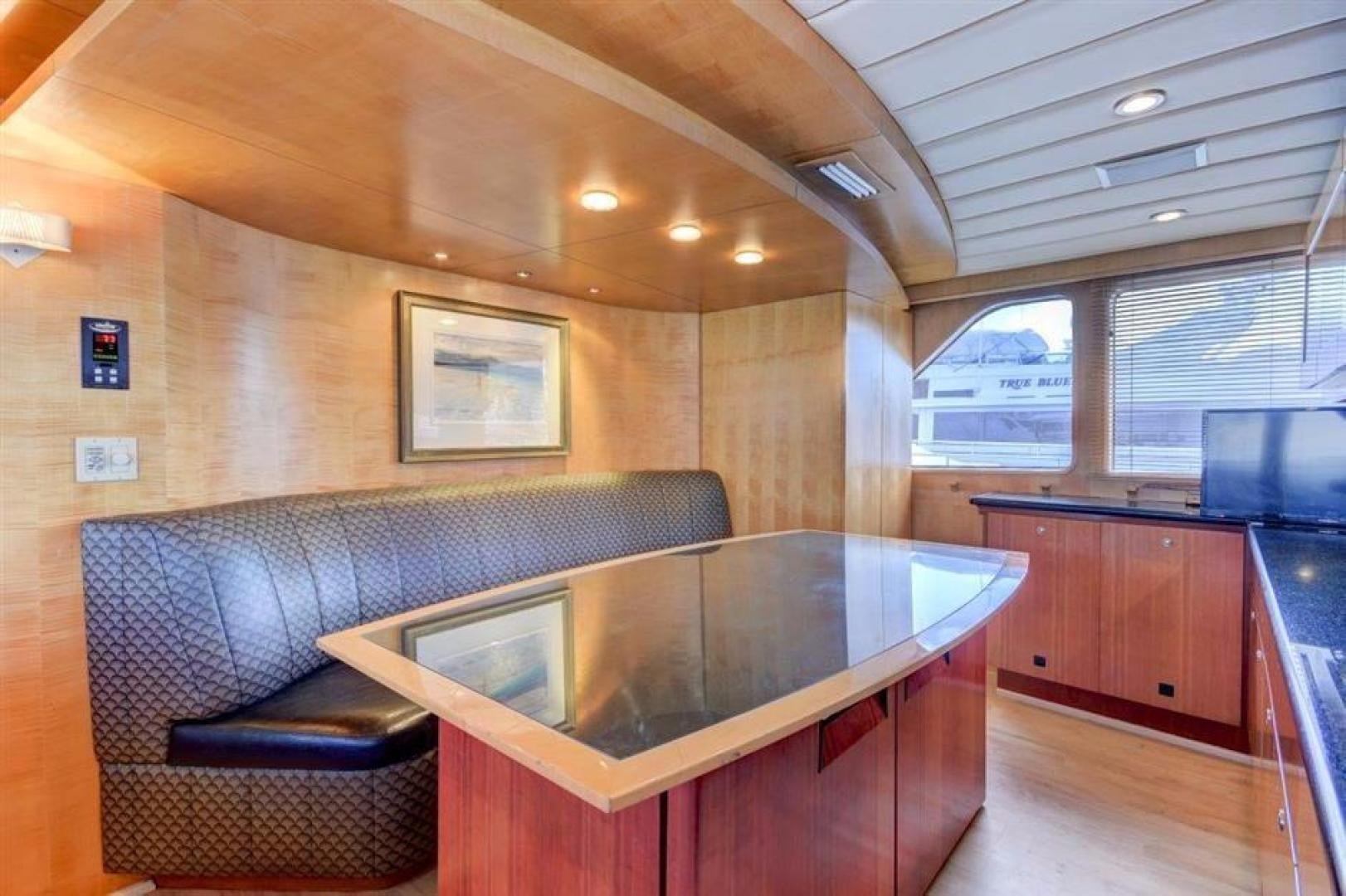 a large room with a table and couches aboard LUCKY STAR Yacht for Sale