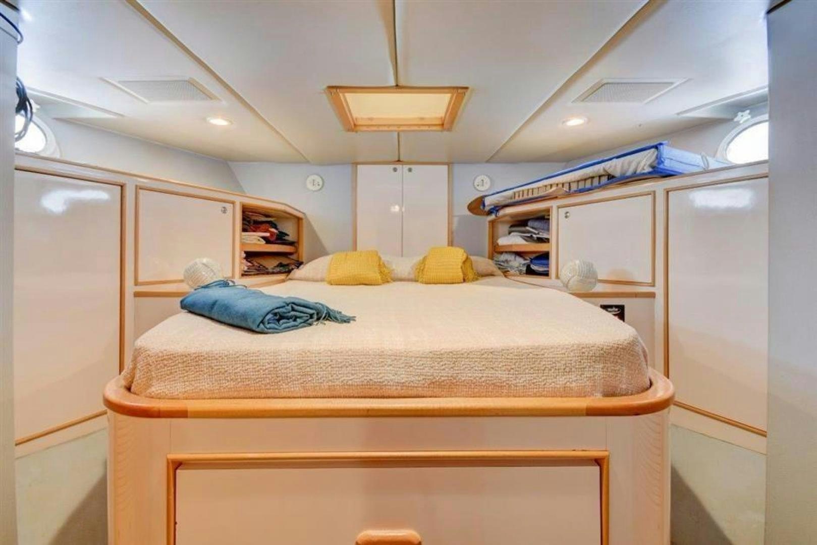 a bedroom with a bed and a closet aboard LUCKY STAR Yacht for Sale