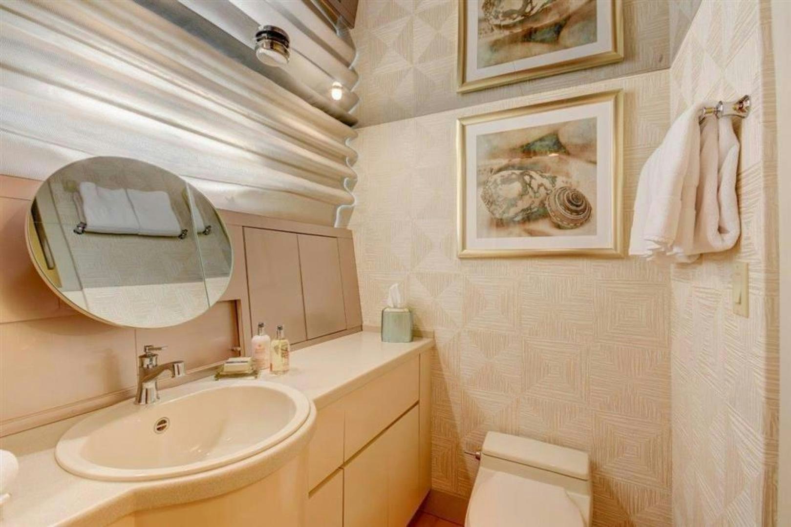 a bathroom with a mirror and towels aboard LUCKY STAR Yacht for Sale