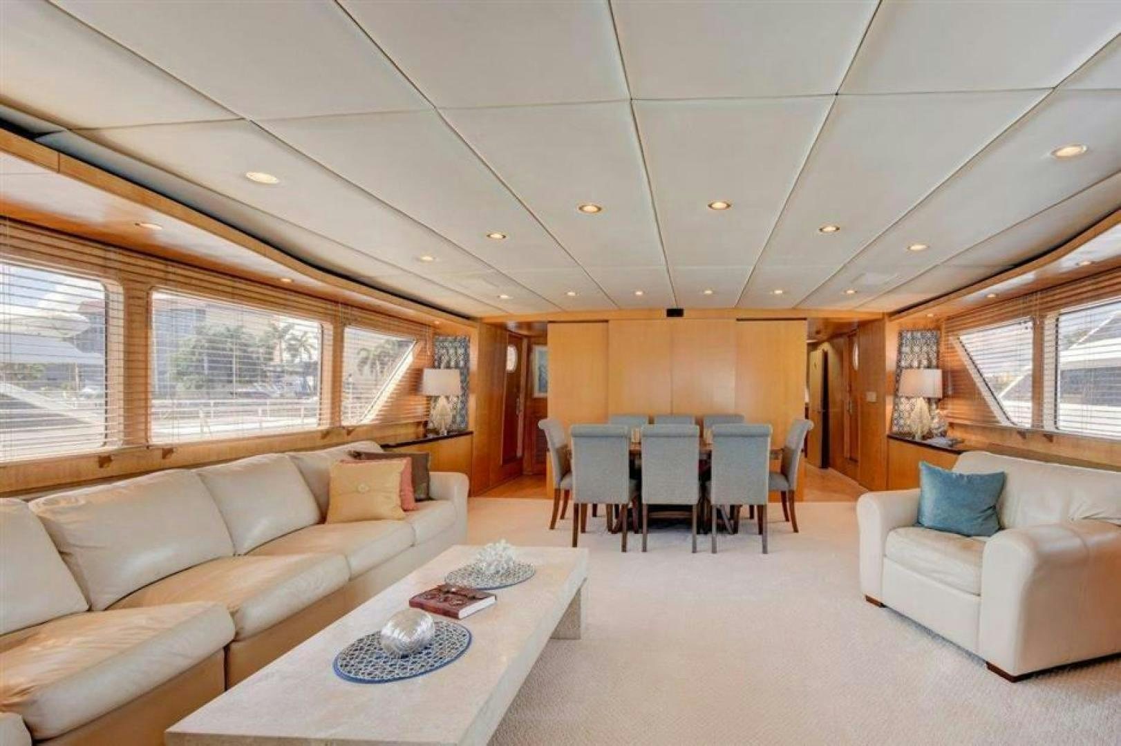 a living room with a couch and a table aboard LUCKY STAR Yacht for Sale