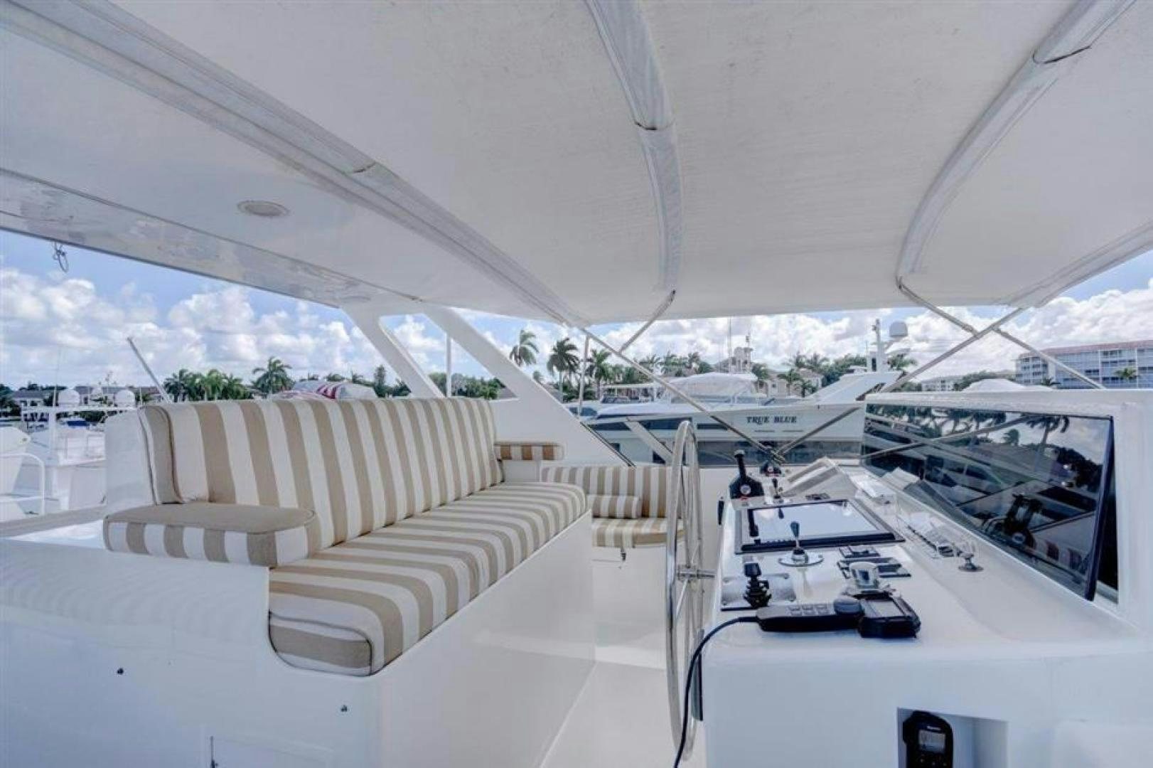 a room with a white couch and white chairs aboard LUCKY STAR Yacht for Sale