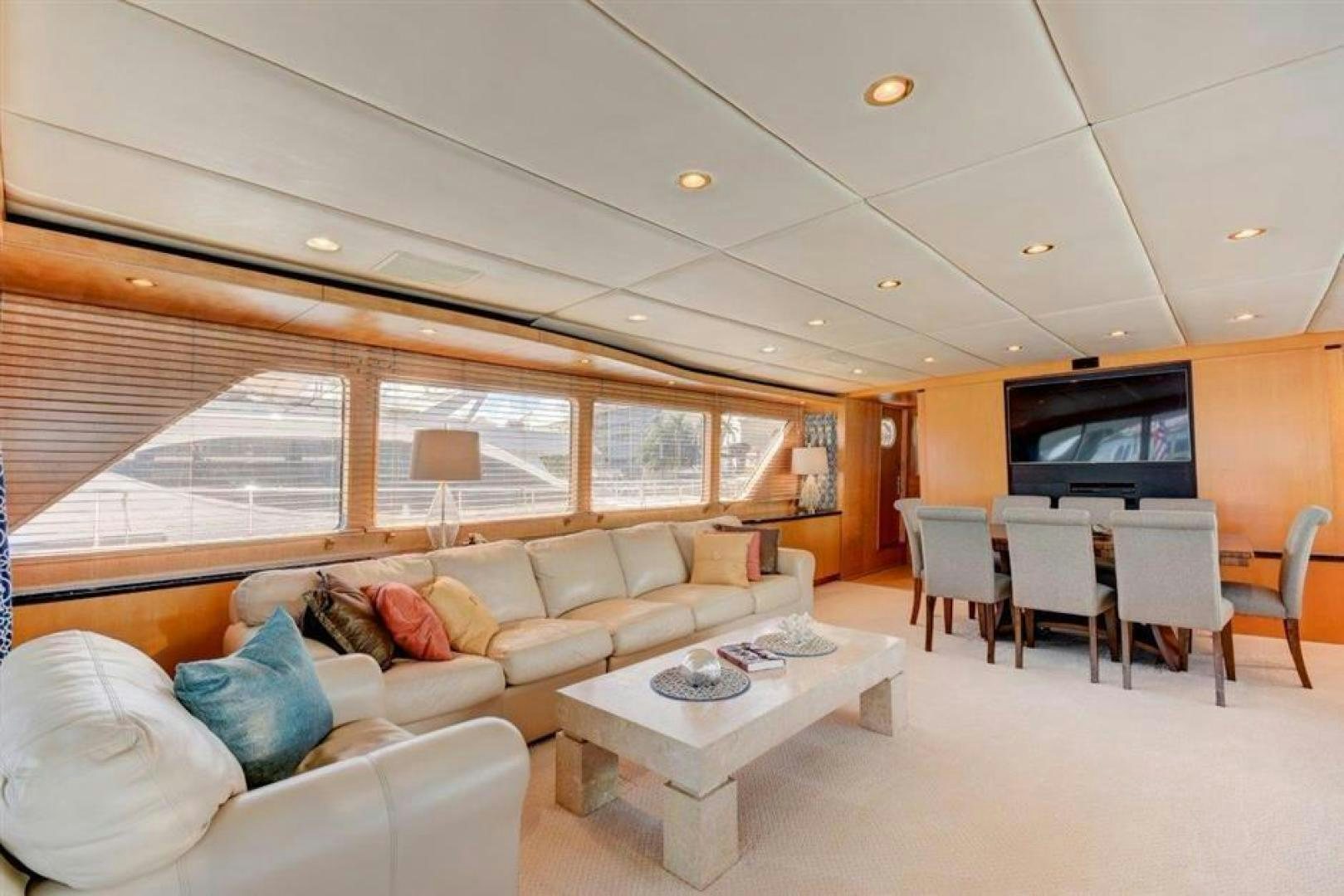 a living room with a couch and a table aboard LUCKY STAR Yacht for Sale