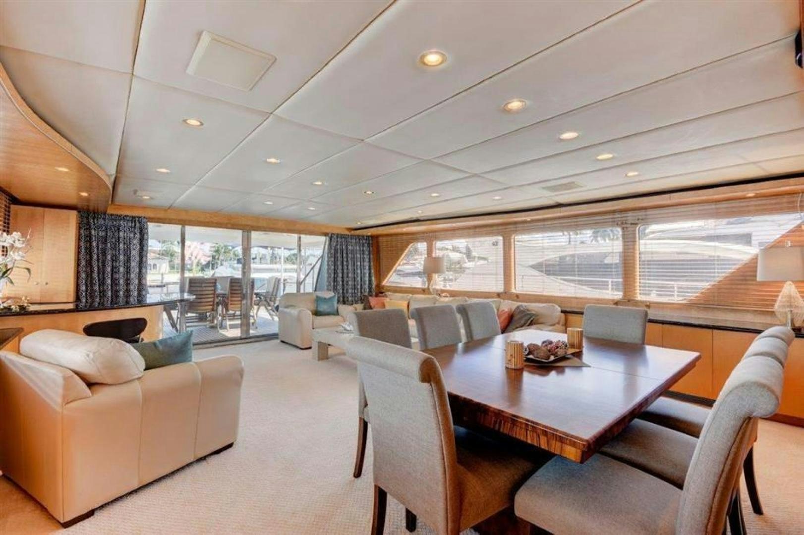 a living room with a large table and chairs aboard LUCKY STAR Yacht for Sale