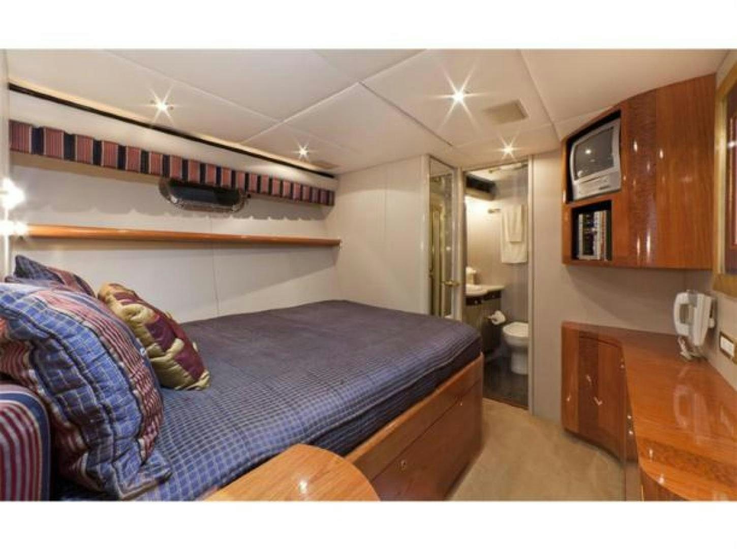 a bedroom with a bed and a television aboard SELF MADE Yacht for Sale