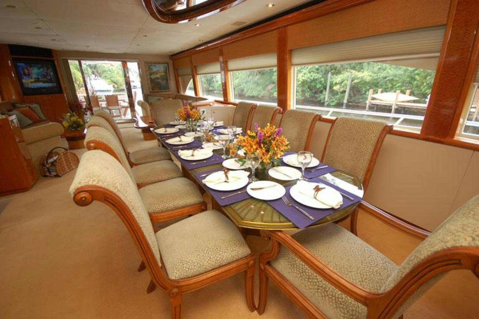 a dining room with a table and chairs aboard SELF MADE Yacht for Sale