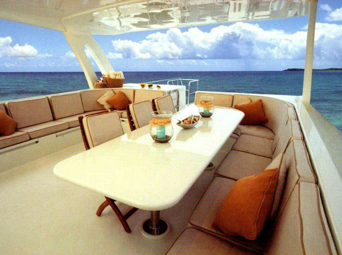 a table with chairs and a couch aboard SELF MADE Yacht for Sale
