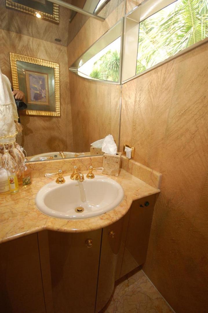 a bathroom with a sink and mirror aboard SELF MADE Yacht for Sale