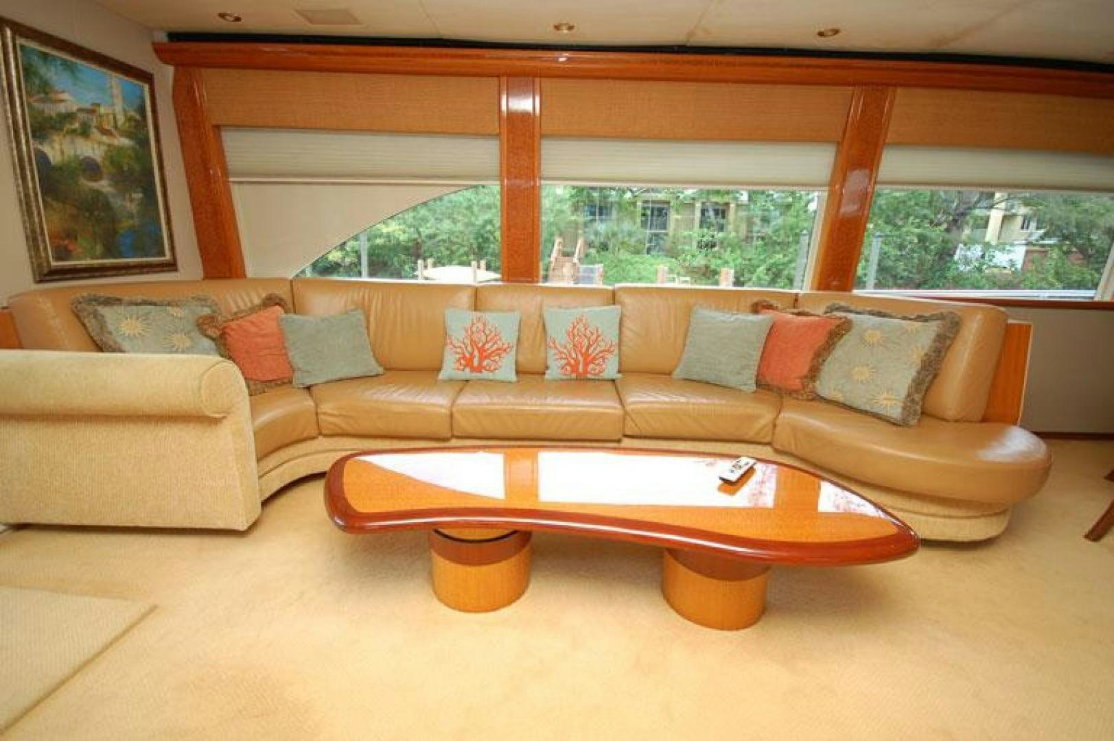 a couch and coffee table in a room with a large window aboard SELF MADE Yacht for Sale