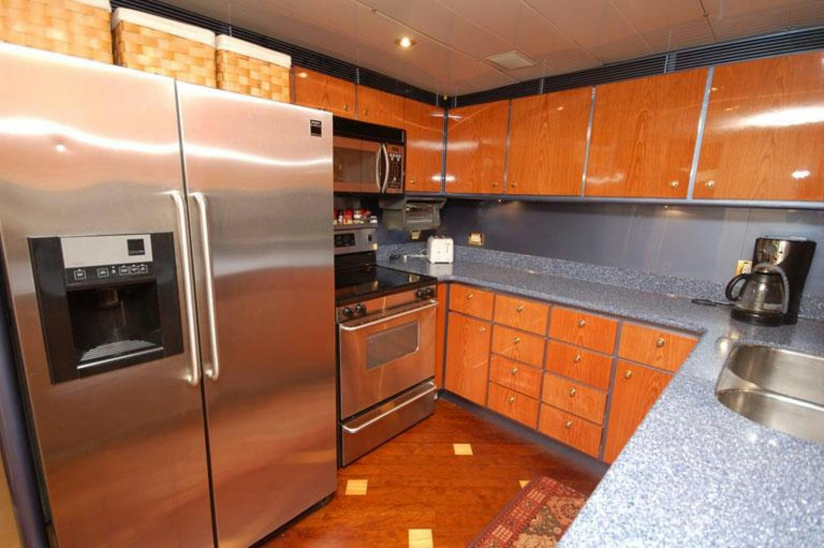 a kitchen with stainless steel appliances aboard SELF MADE Yacht for Sale