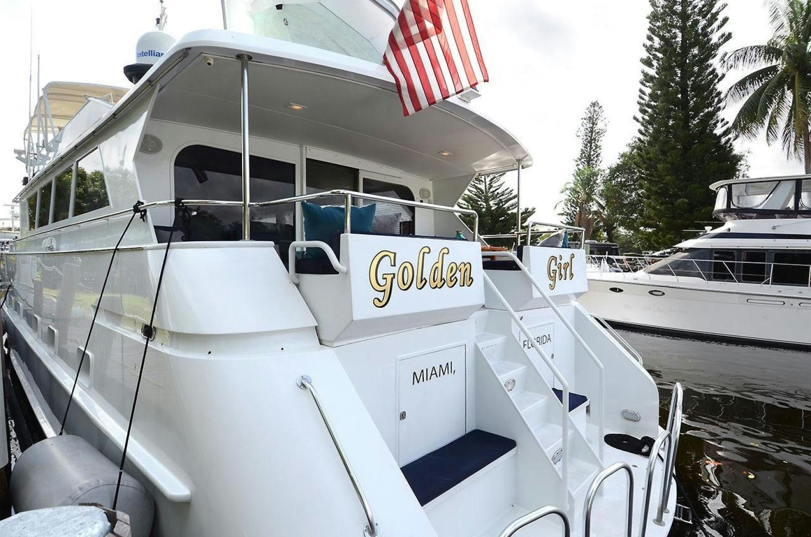 a boat with a flag on the front aboard GOLDEN GIRL Yacht for Sale