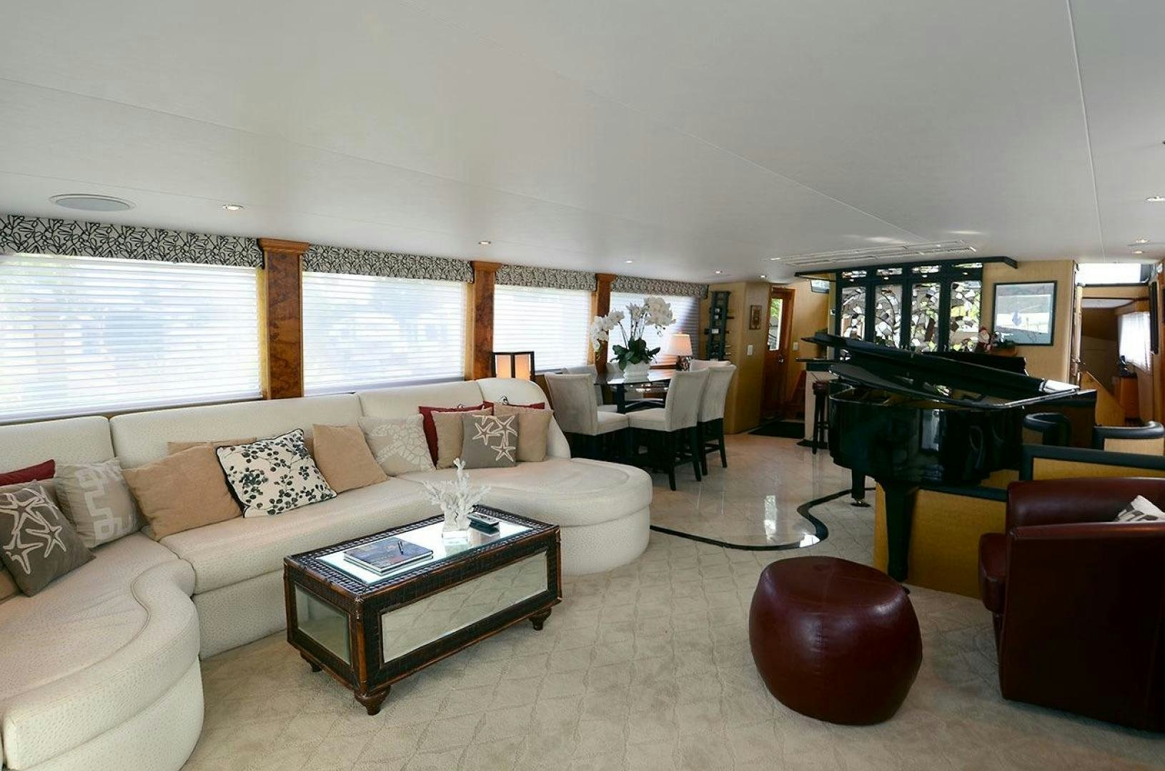 a living room with a piano and a piano aboard GOLDEN GIRL Yacht for Sale