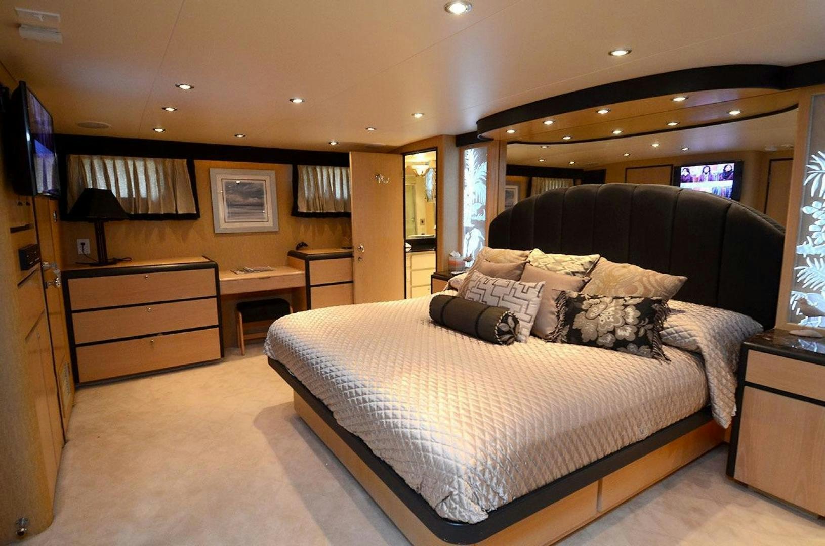 a bedroom with a bed and a desk aboard GOLDEN GIRL Yacht for Sale