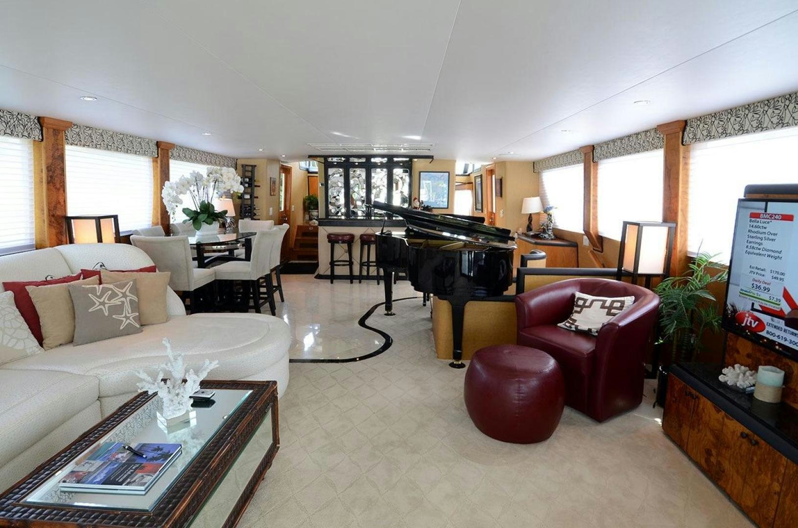 a living room with a piano and a piano aboard GOLDEN GIRL Yacht for Sale