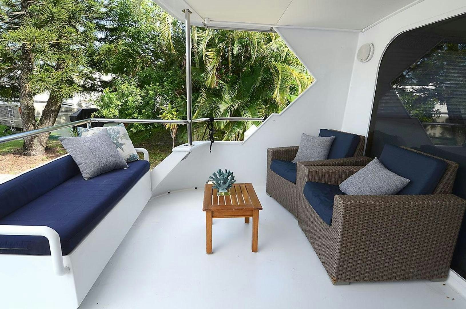 a deck with couches and a table aboard GOLDEN GIRL Yacht for Sale