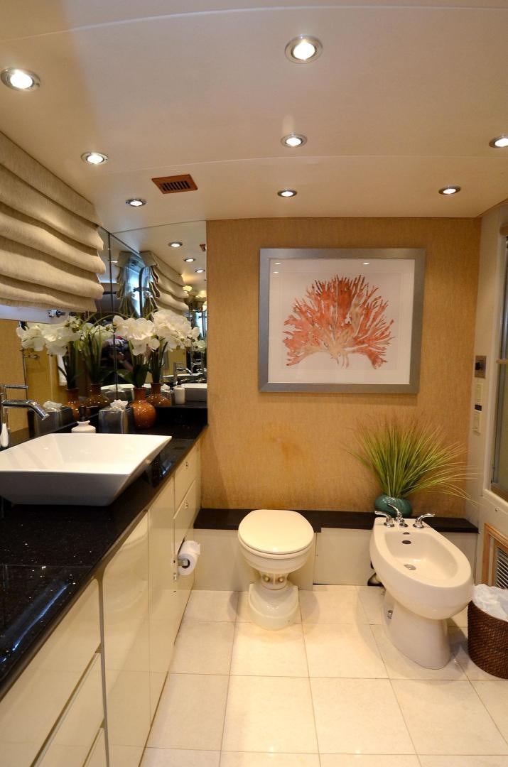 a bathroom with a sink toilet and a mirror aboard GOLDEN GIRL Yacht for Sale
