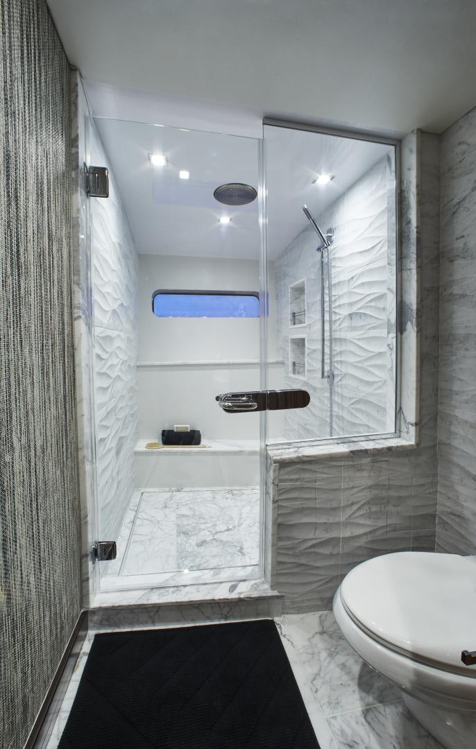 a bathroom with a shower and toilet aboard M90 PANACERA Yacht for Sale