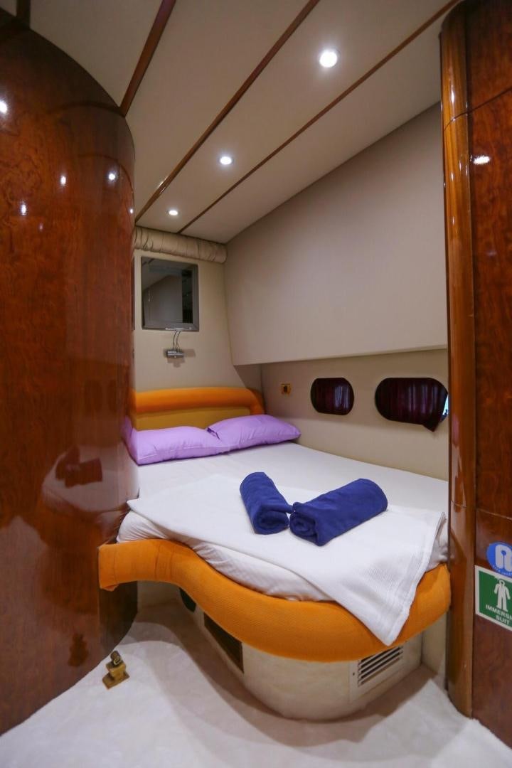a bed with a blue blanket aboard NO NAME Yacht for Sale
