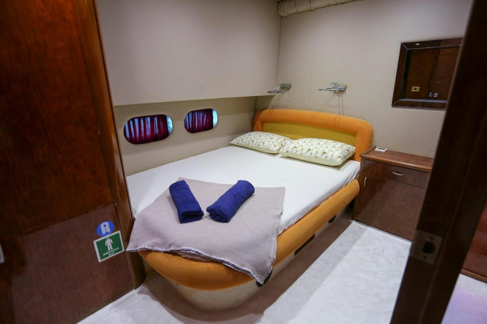 a room with a bed and a desk aboard NO NAME Yacht for Sale