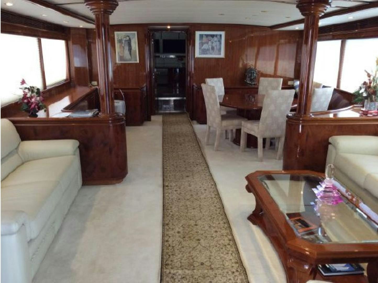 a living room with a wood dining table and a couch aboard NO NAME Yacht for Sale