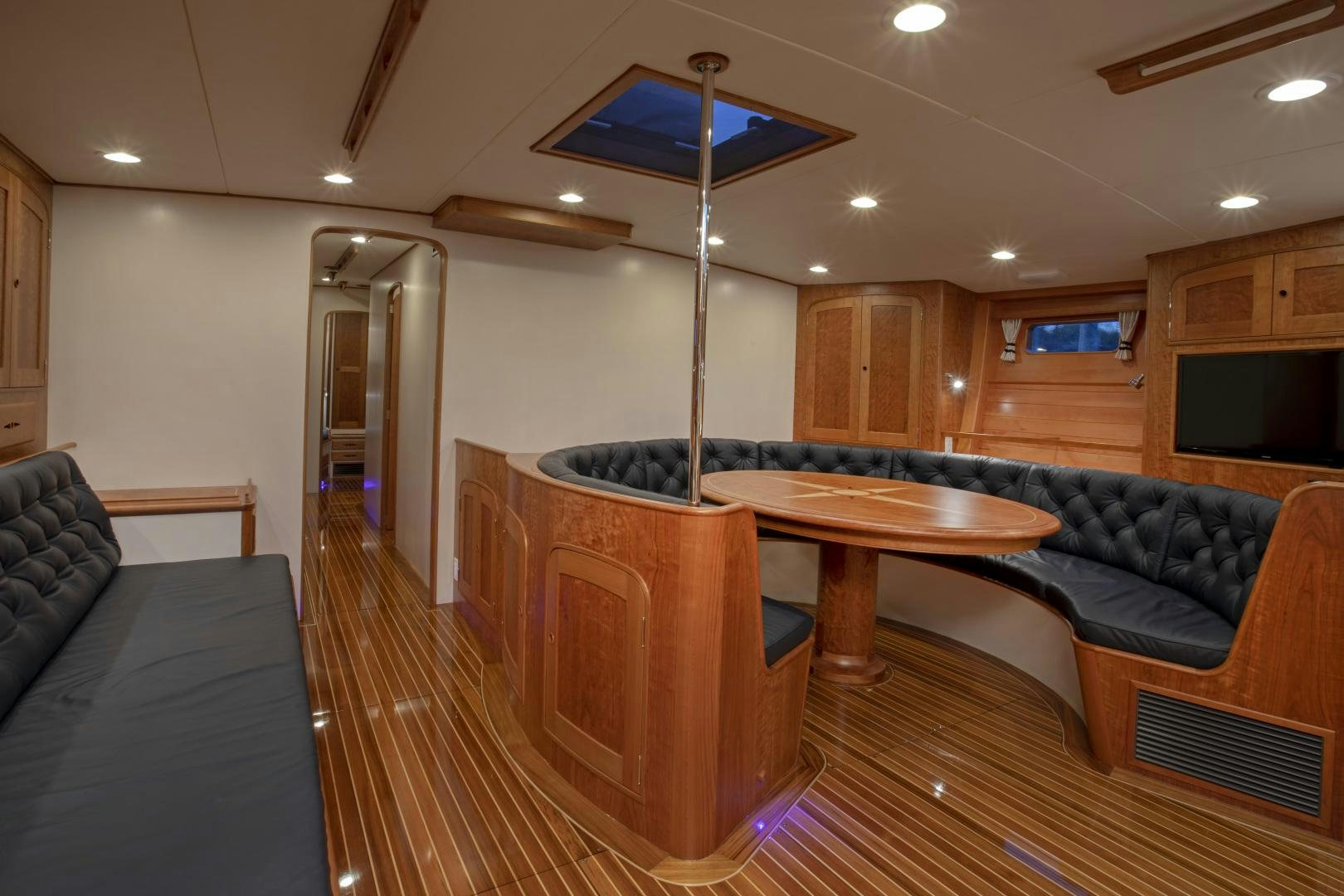 a living room with a couch and a table aboard SONNY III Yacht for Sale