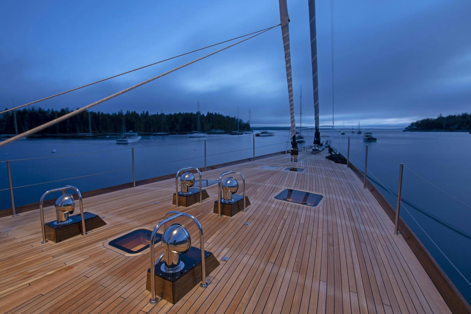 a deck with chairs and a body of water in the background aboard SONNY III Yacht for Sale