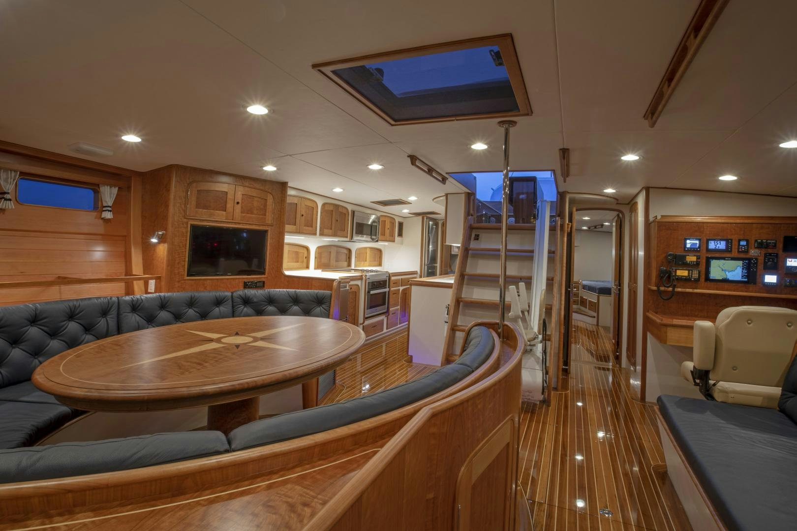 a living room with a wood table aboard SONNY III Yacht for Sale