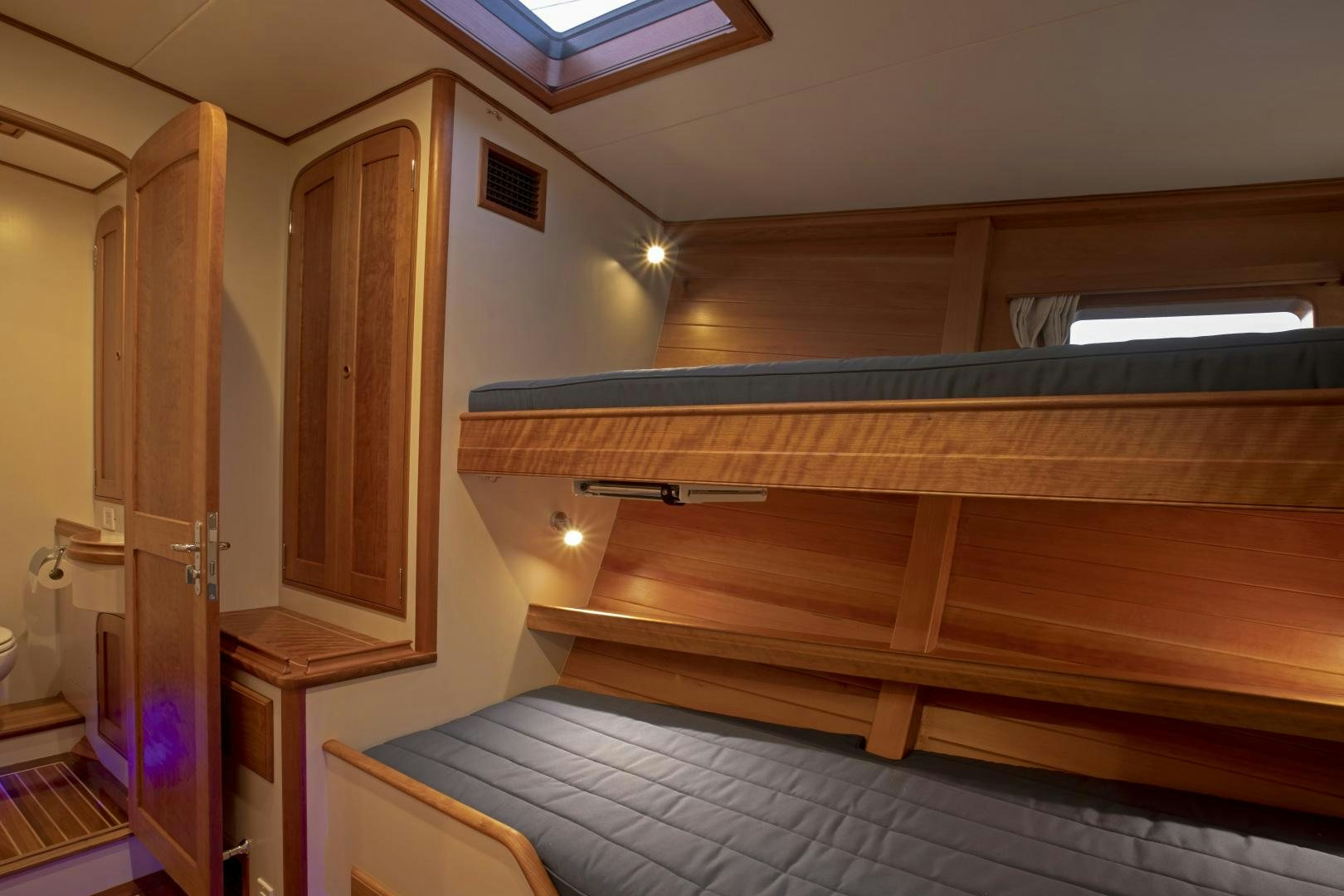 a room with wooden cabinets aboard SONNY III Yacht for Sale