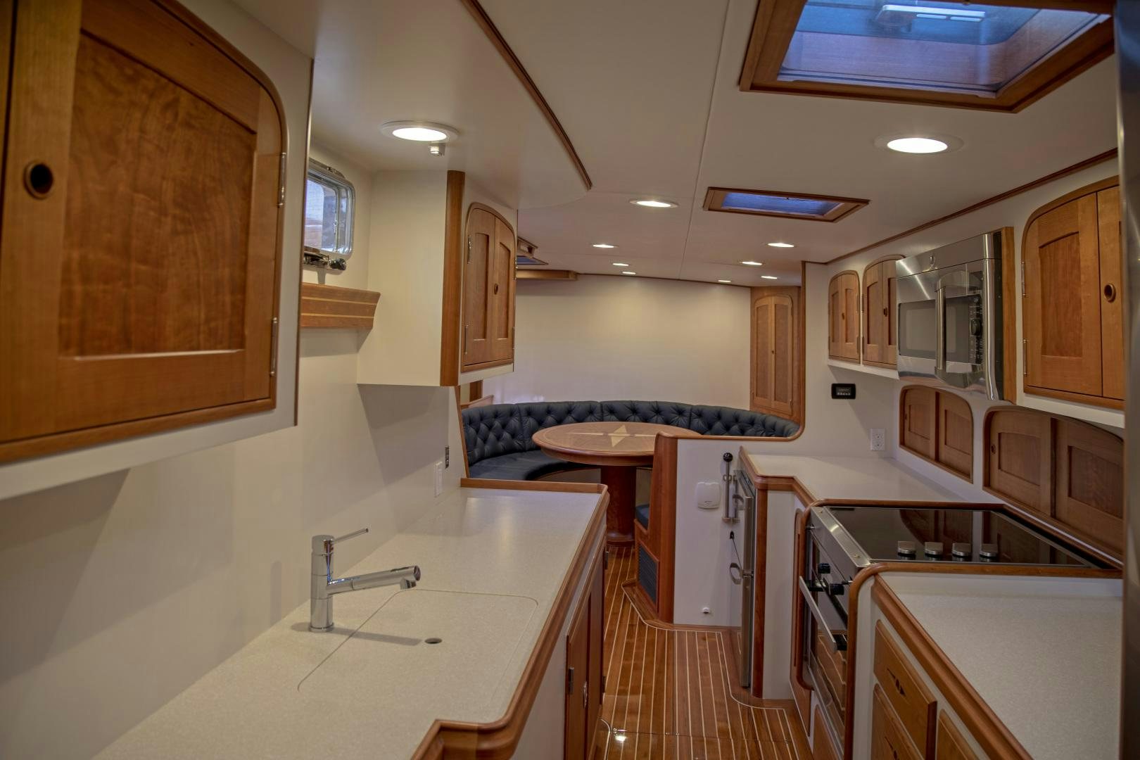 a kitchen with a table and a couch aboard SONNY III Yacht for Sale