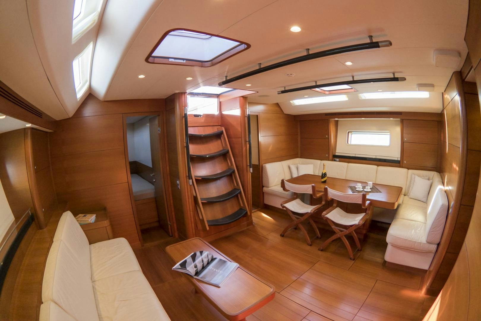a room with a staircase and chairs aboard B5 Yacht for Sale