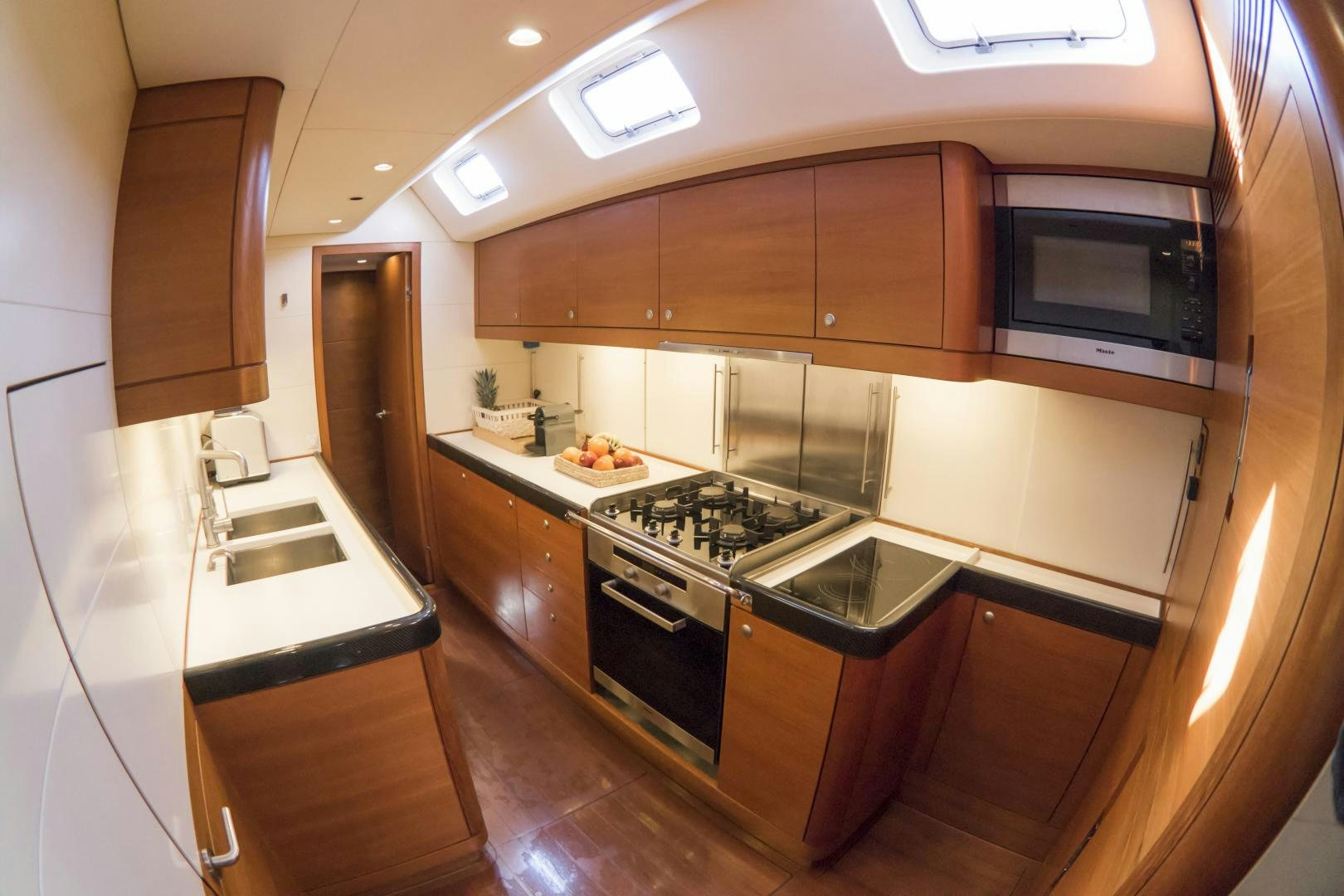 a kitchen with wooden cabinets aboard B5 Yacht for Sale
