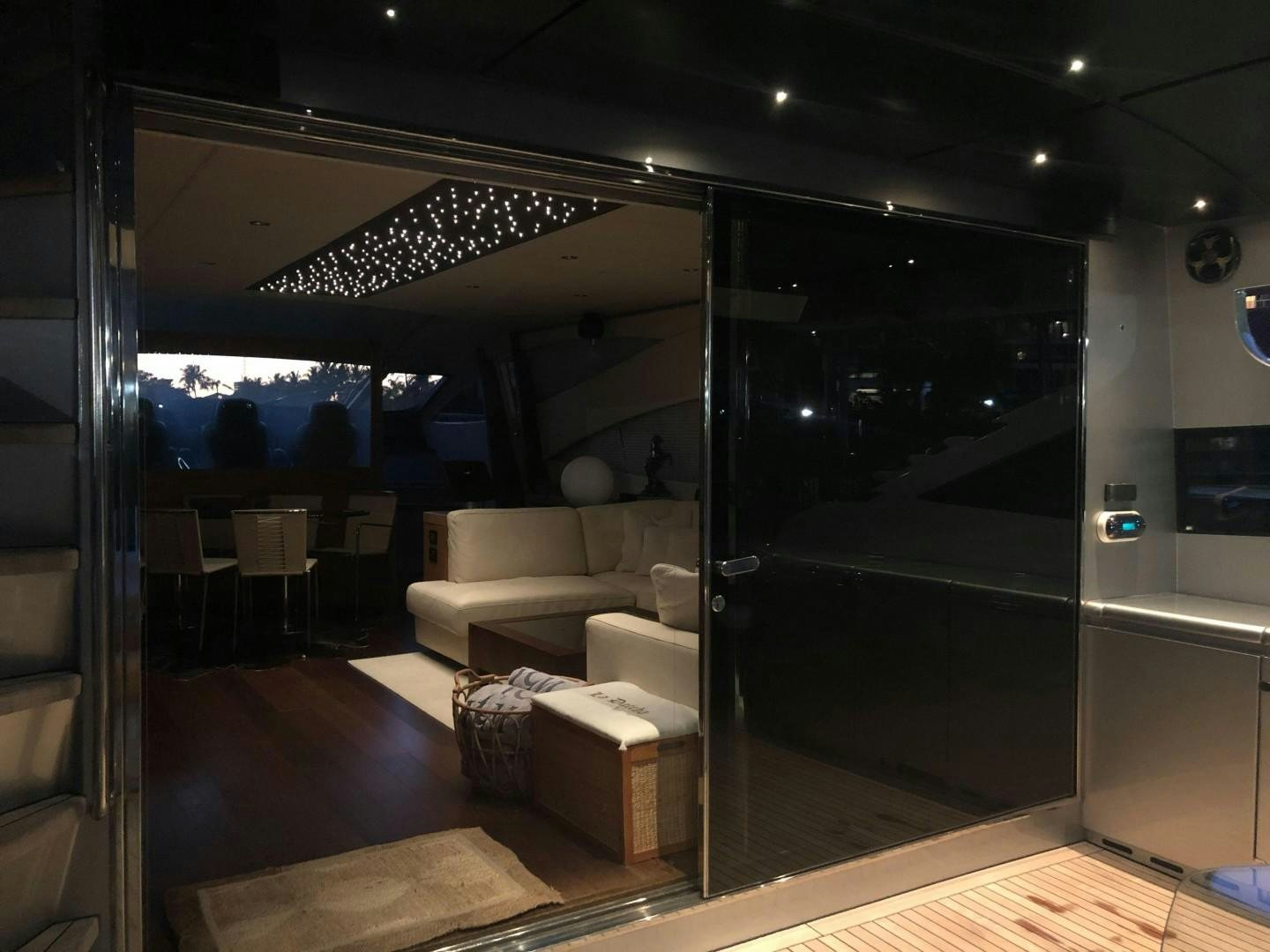 a room with a couch and a table and a tv aboard YCM 90 Yacht for Sale