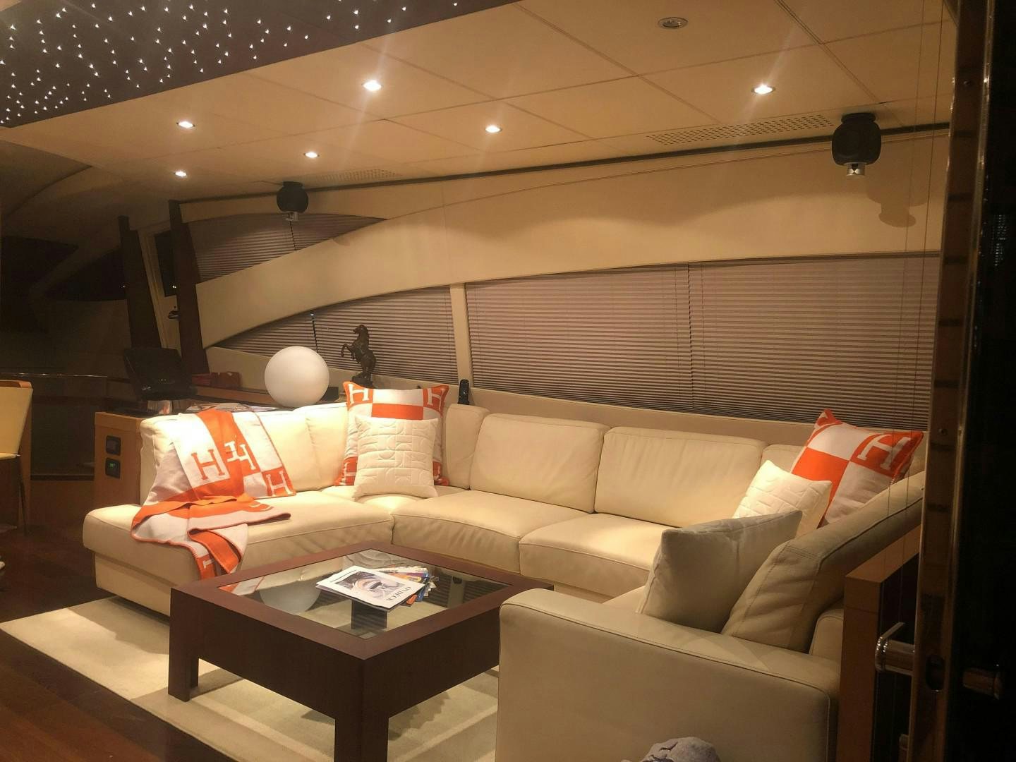 a living room with a couch and a table aboard YCM 90 Yacht for Sale