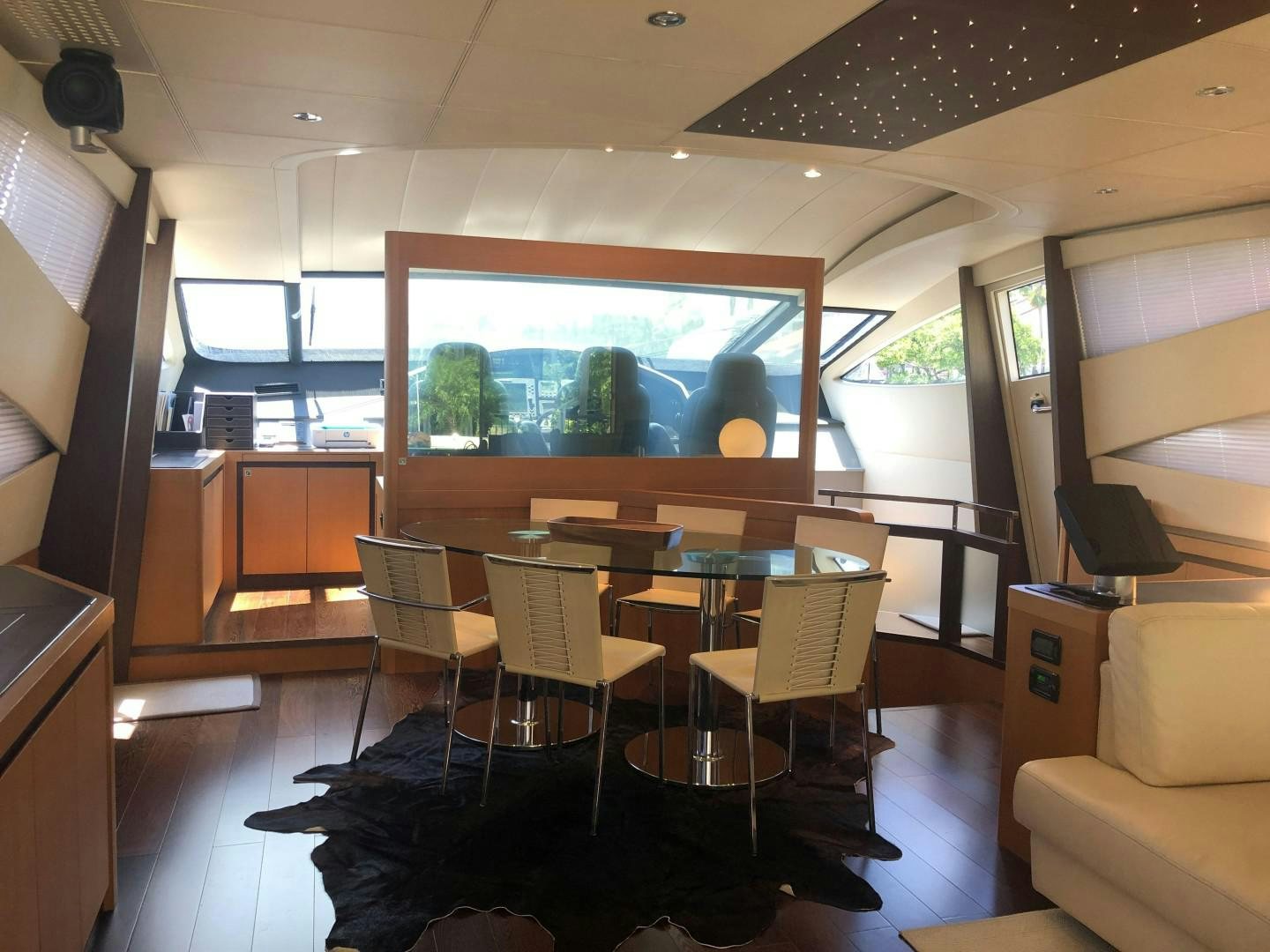 a room with a table and chairs aboard YCM 90 Yacht for Sale